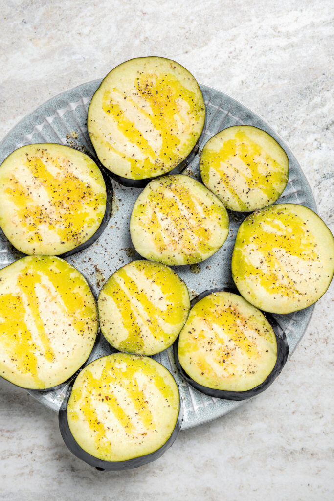 This saucy air fryer eggplant parmesan recipe with fresh mozzarella is the perfect veggie appetizer for dinner parties. Seasoning the eggplant.