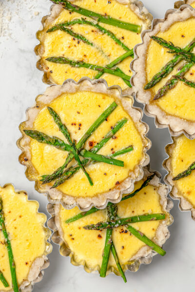 Several asparagus tartlets with lemon-parmesan curd filling.