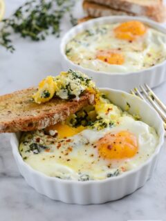 Baked Egg Ricotta Thyme Cups with a slice of bread.