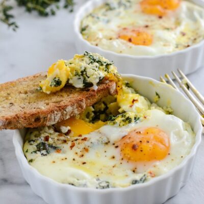 Baked Egg Ricotta Thyme Cups with a slice of bread.