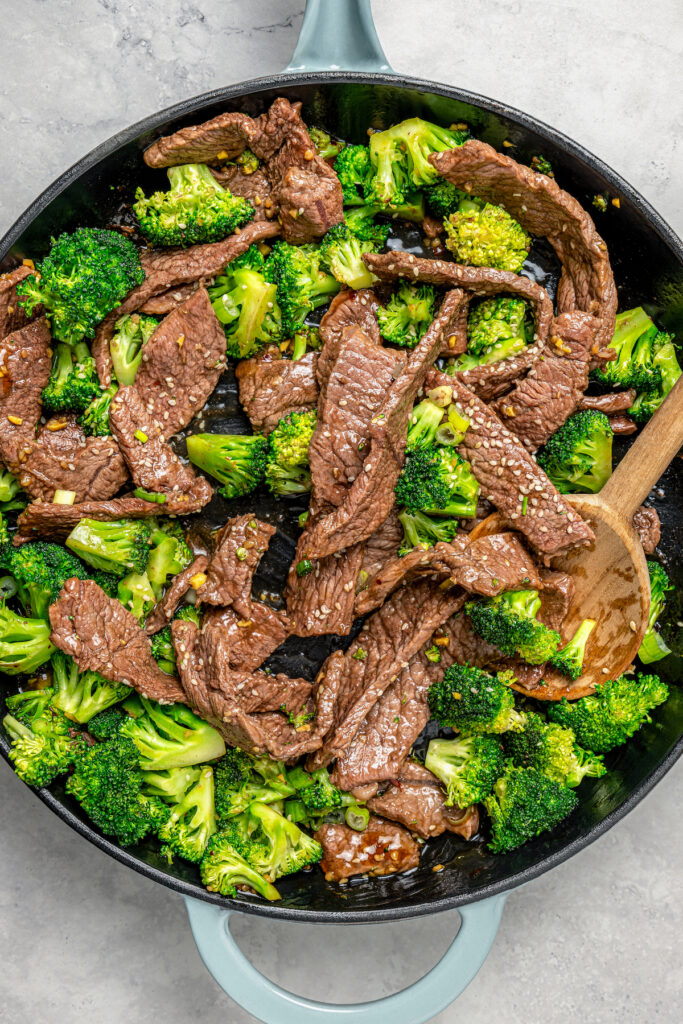 This beef and broccoli recipe with honey, garlic, and red pepper flakes is a spicy, saucy Asian-style dinner that beats take-out any day. Mixing everything in the pan.