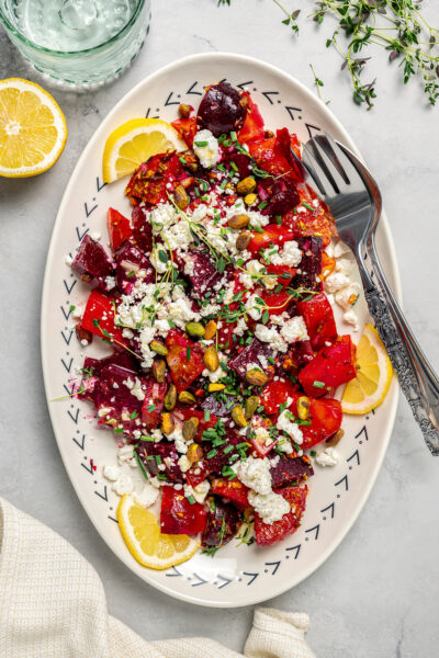 An overhead shot of beet salad on an oval platter.