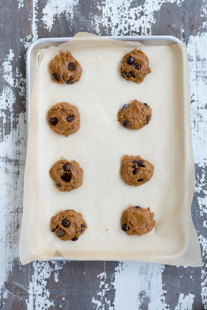 These healthy Peanut Butter Chocolate Protein Cookies are a wholesome, easy-to-make treat that the whole family will love. Unbaked cookies on a baking sheet.