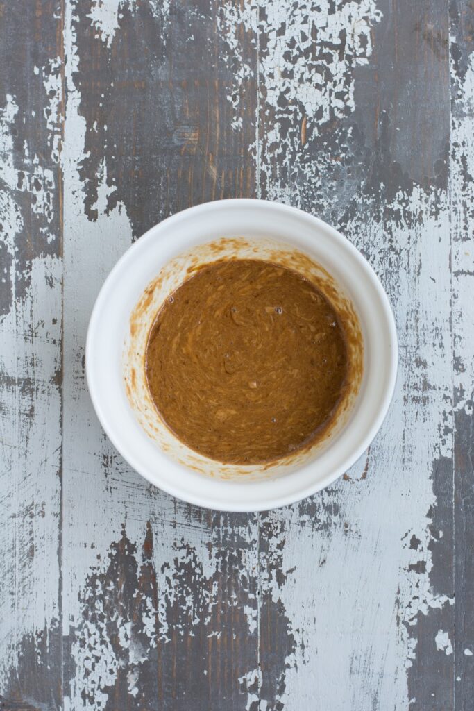 These healthy Peanut Butter Chocolate Protein Cookies are a wholesome, easy-to-make treat that the whole family will love. Wet ingredients mixed together in a bowl.
