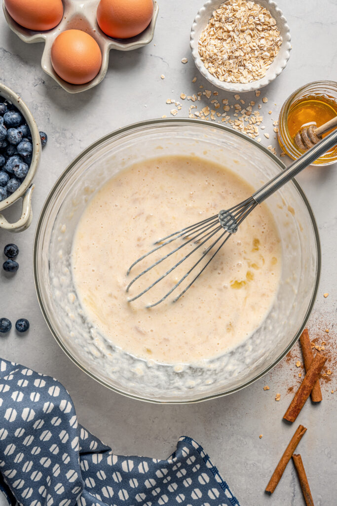 This naturally-sweetened blueberry protein muffins recipe with cinnamon and orange zest is a great on-the-go breakfast. Whisking the wet ingredients until smooth.