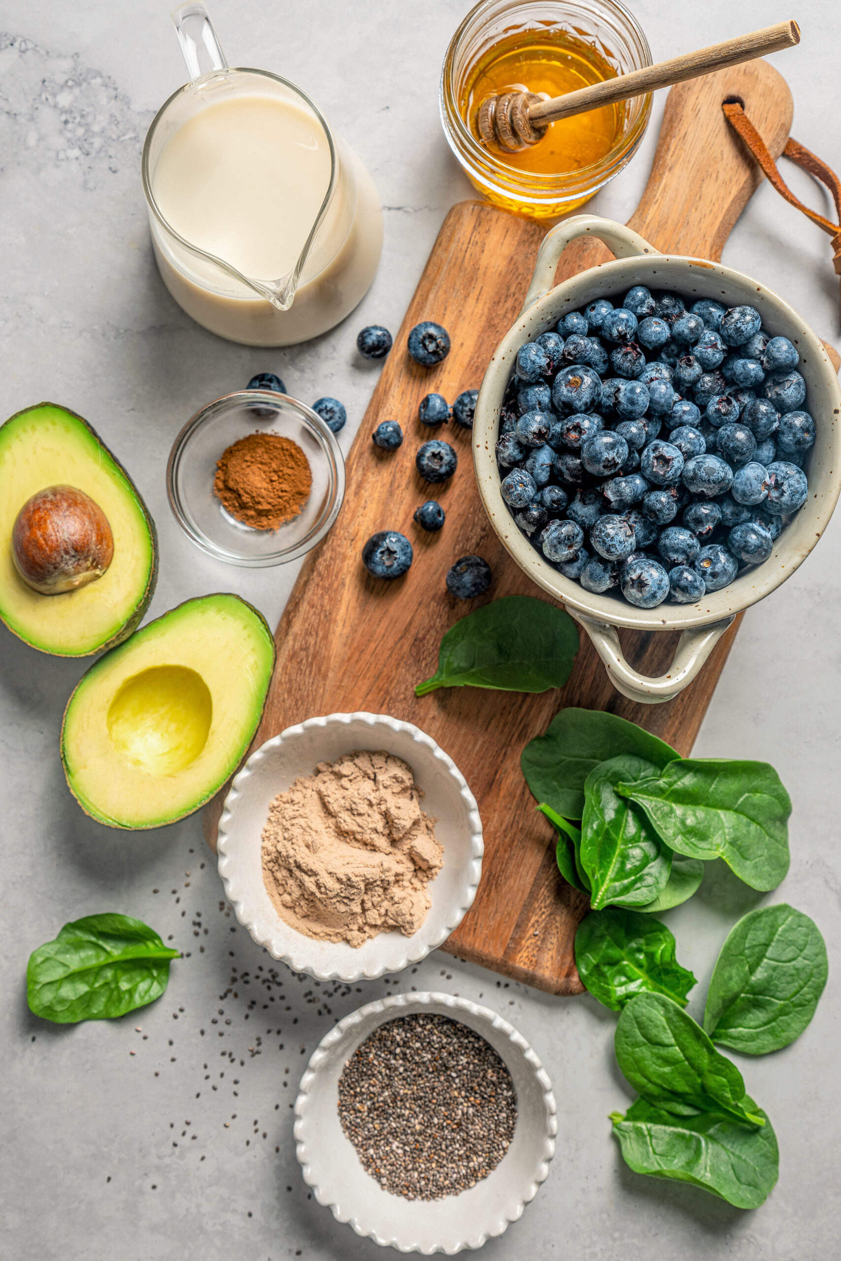 This blueberry-chia superfood smoothie recipe with spinach, avocado, and honey is the perfect way to start your mornings. Ingredients for making a superfood smoothie.