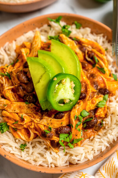 Bowls of shredded chicken and rice with beans.
