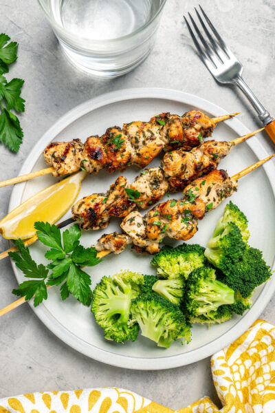 Overhead shot of a chicken dinner served with broccoli.