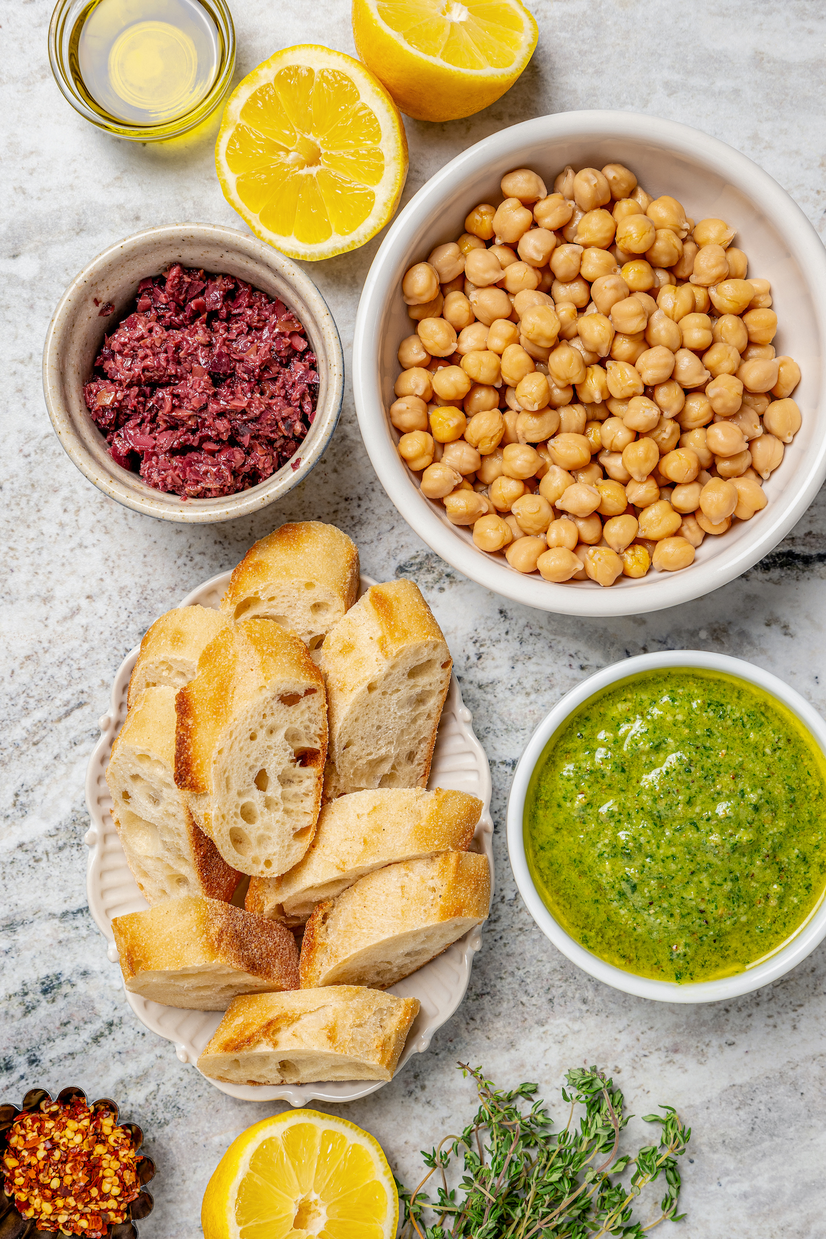 This zesty chickpea bruschetta recipe with herby pesto and salty olives on toasty bread is a 20-minute summer appetizer. Ingredients for the chickpea bruschetta recipe.
