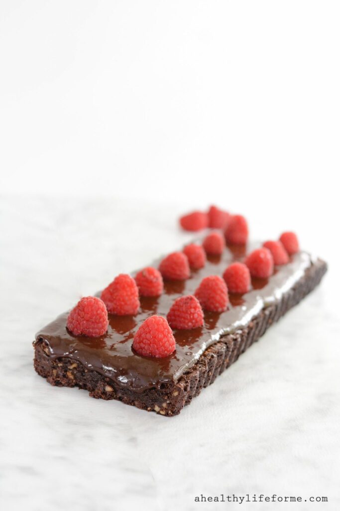 Chocolate Walnut Tart with Raspberries is a triple dose of chocolate that makes this one incredible dessert. I kept the recipe clean, so this tart is gluten free, dairy free and paleo friendly.