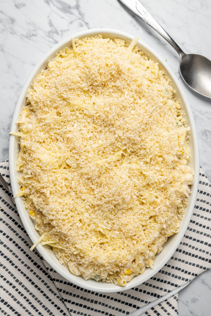 This Creamy Mac and Cheese with Jalapeño and Corn is a little spicy, a little sweet, and very, very cheesy. Irresistible and easy to make! A casserole topped with breadcrumbs.