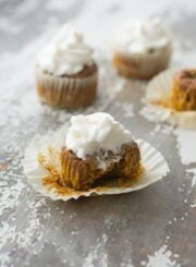 A bite taken out of a pumpkin pie cupcake
