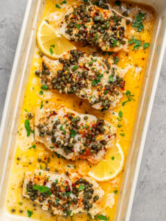 Pieces of fish baked in a dish with butter and seasonings.