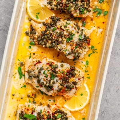 Pieces of fish baked in a dish with butter and seasonings.
