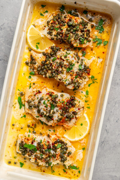 Pieces of fish baked in a dish with butter and seasonings.