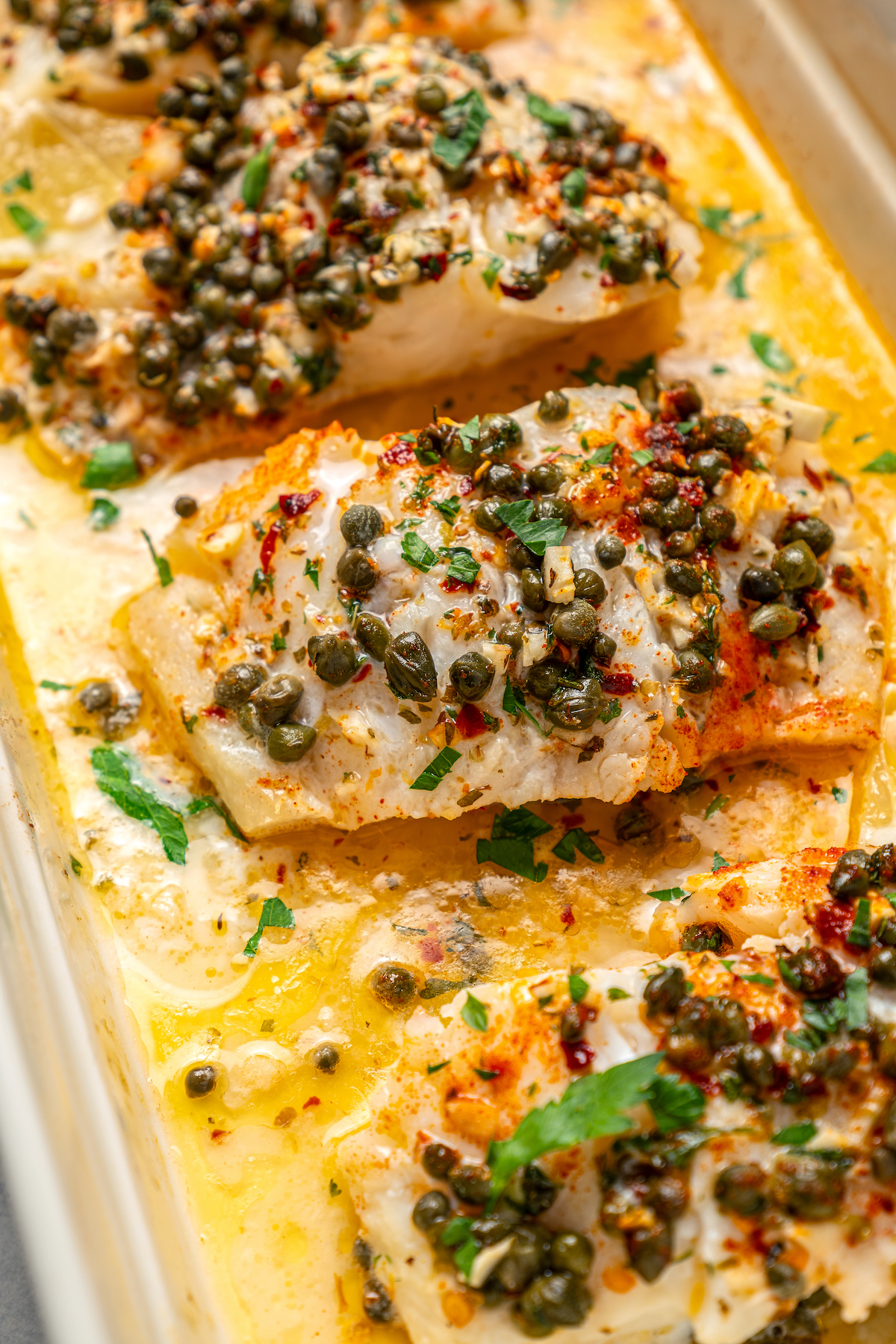 You'll crave the light, fresh flavors of this easy Baked Cod Recipe. Simple prep, perfect texture, and zingy flavor - what could be better? Baked cod recipe with buttery herb sauce.