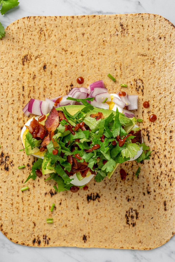 This Egg and Avocado Breakfast Wrap is low-carb and loaded with protein. Healthy, clean, and delicious, it’s a quick breakfast you'll crave! An avocado and egg wrap, ready to roll up.
