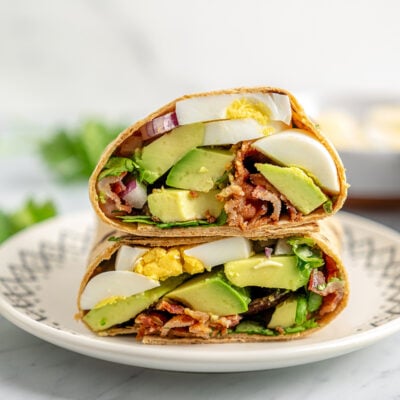 Egg and avocado breakfast wrap on a plate.