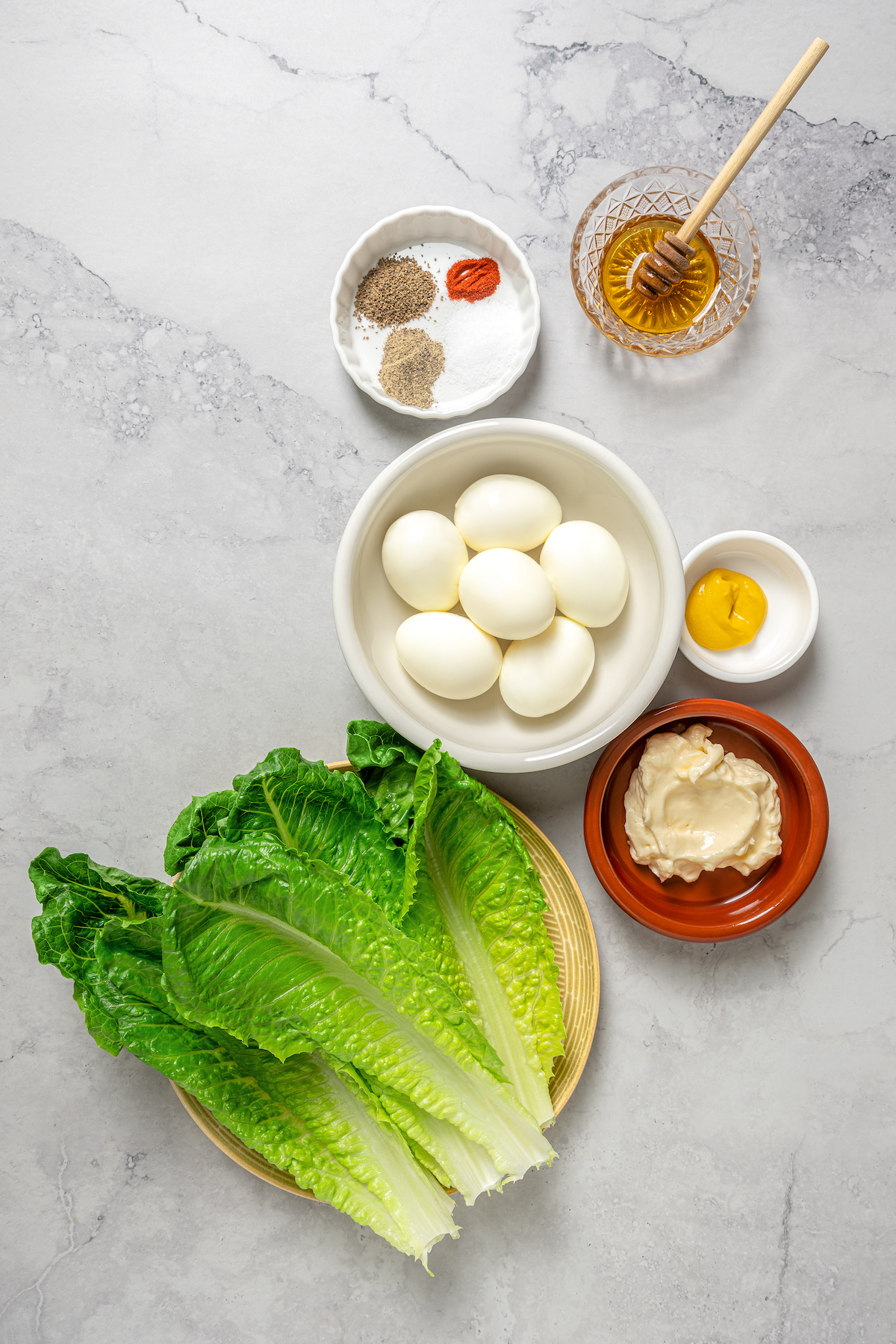 This Healthy Egg Salad is a simple, tasty recipe that’s packed with protein and easy to prepare. A scrumptious lunch or midday snack! Ingredients for healthy egg salad, arranged on a work surface.