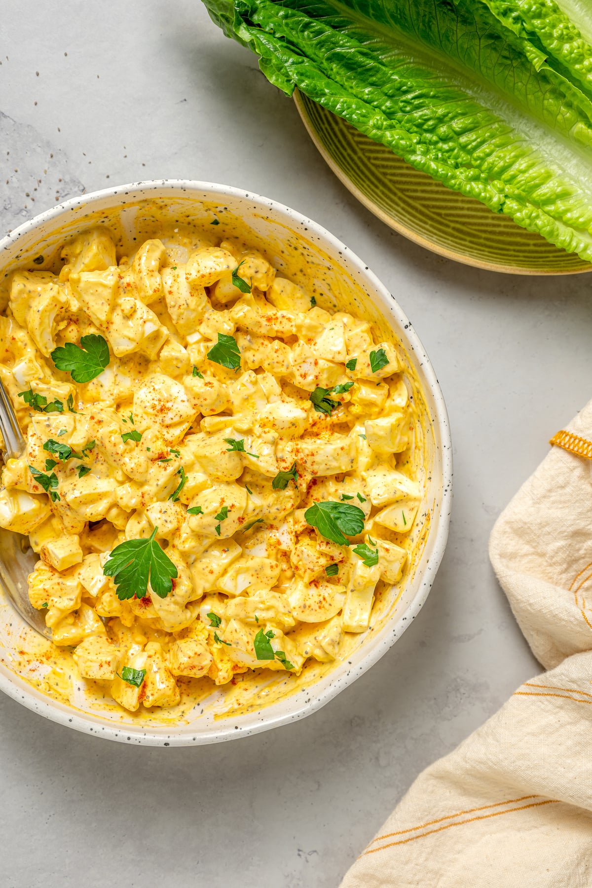 This Healthy Egg Salad is a simple, tasty recipe that’s packed with protein and easy to prepare. A scrumptious lunch or midday snack! Homemade hard-boiled egg salad garnished with herbs.