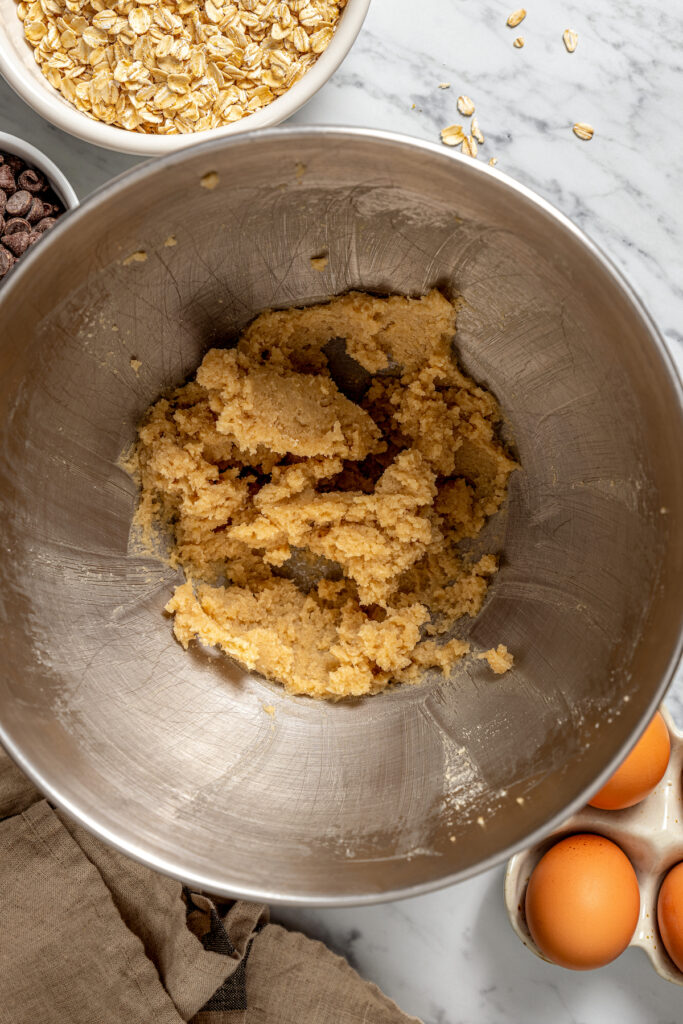 This banana oatmeal chocolate chip cookies recipe is warmly spiced with cinnamon and cardamom for a comforting, freshly baked treat. Creamed butter and sugars in a mixing bowl.