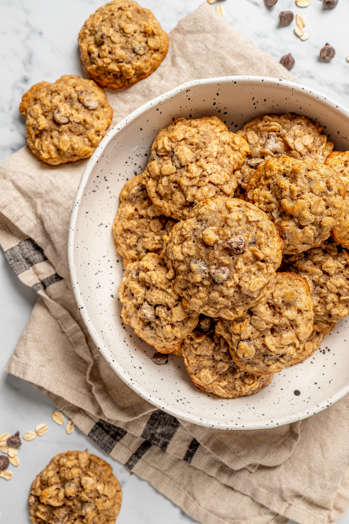 This banana oatmeal chocolate chip cookies recipe is warmly spiced with cinnamon and cardamom for a comforting, freshly baked treat. Bowl of banana oatmeal chocolate chip cookies.