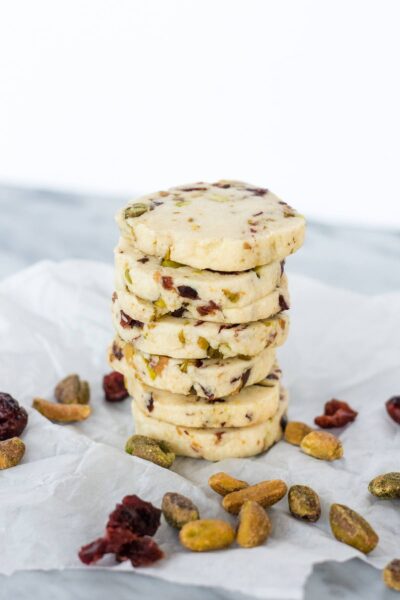 A stack of cookies with cranberries and pistachios.