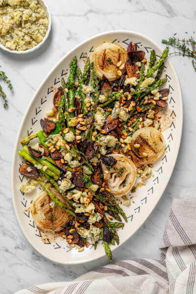 An asparagus salad with toppings and vinaigrette.
