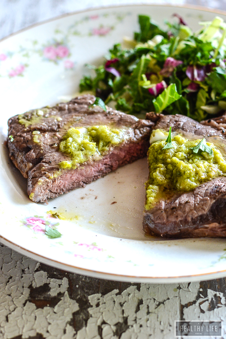 This juicy, 10-minute bison steak recipe with avocado butter will keep you busy at all your cookouts this year. Sliced bison steak with garlic-avocado butter on top.