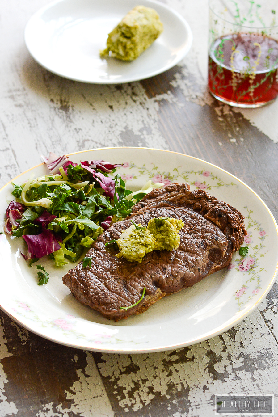 This juicy, 10-minute bison steak recipe with avocado butter will keep you busy at all your cookouts this year. Grilled bison steak with a side salad.