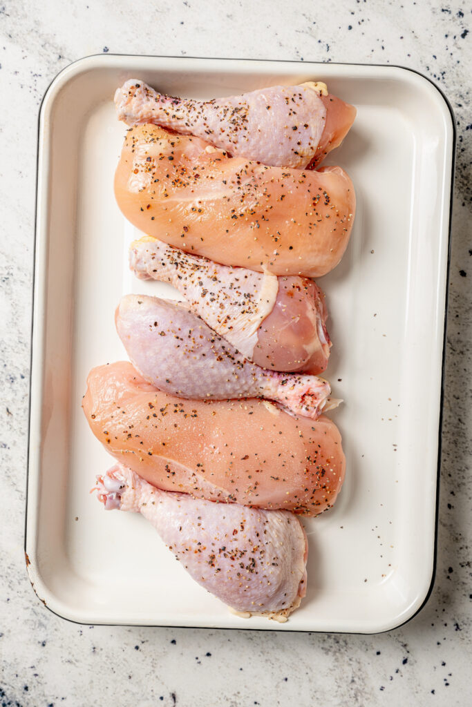 This perfectly juicy grilled chicken recipe with homemade sweet-and-savory sauce is an easy Asian-style dinner. Seasoned chicken in a tray.