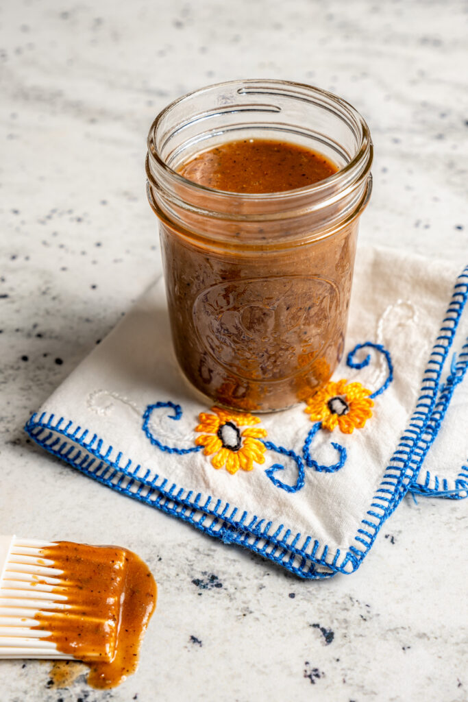This perfectly juicy grilled chicken recipe with homemade sweet-and-savory sauce is an easy Asian-style dinner. Blended sauce in a glass jar.