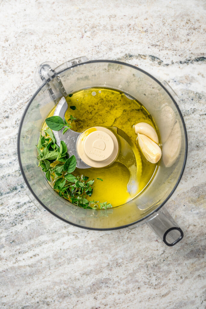This juicy grilled tri tip recipe with homemade Sicilian herb sauce is an easy dinner for your next summer cookout. Adding the sauce ingredients to the food processor.