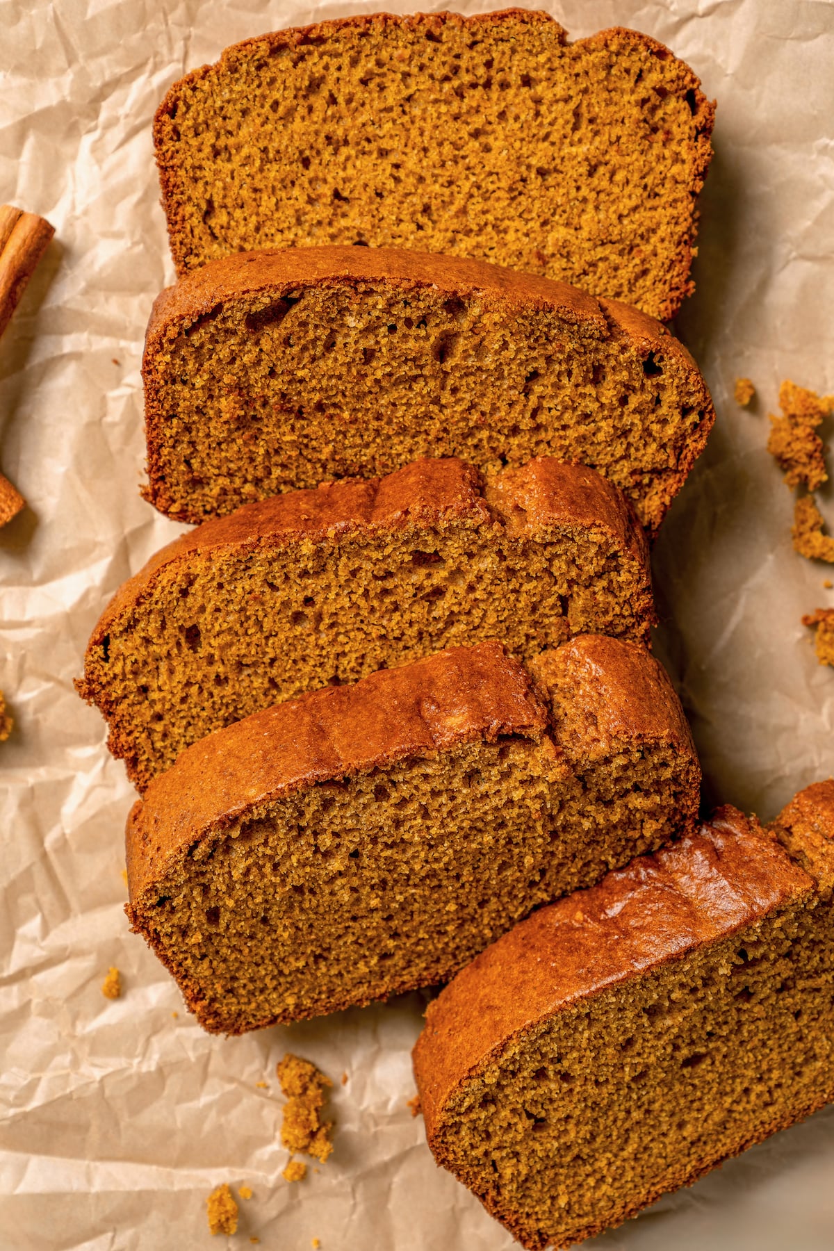 This spiced pumpkin bread recipe with whole-wheat flour, creamy yogurt, and brown sugar is the perfect fall-flavored breakfast. Sliced, freshly-baked pumpkin bread.