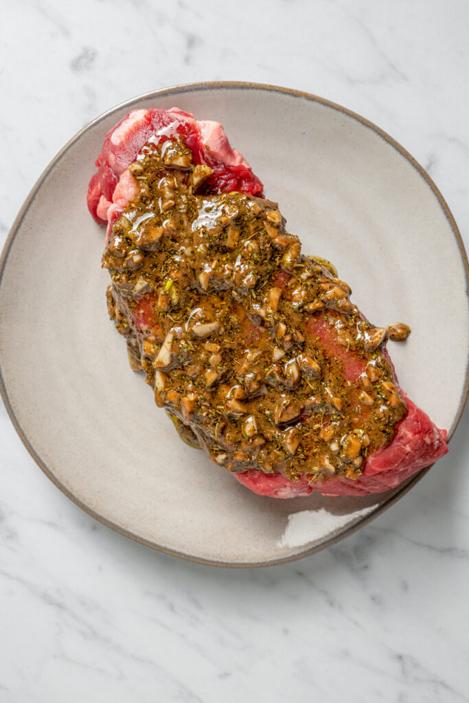 This Pan Seared Steak Recipe with Roasted Vegetables is hearty, filling, and easy to make. A crazy-good marinade brings it all together! Marinade rubbed into a steak.