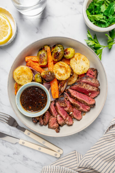 A steak dinner on a white dinner plate.