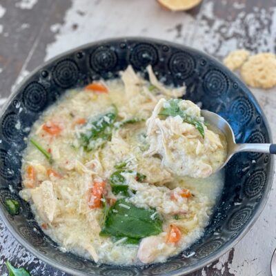 LEMON CHICKEN RICE SOUP in a bowl with spoon