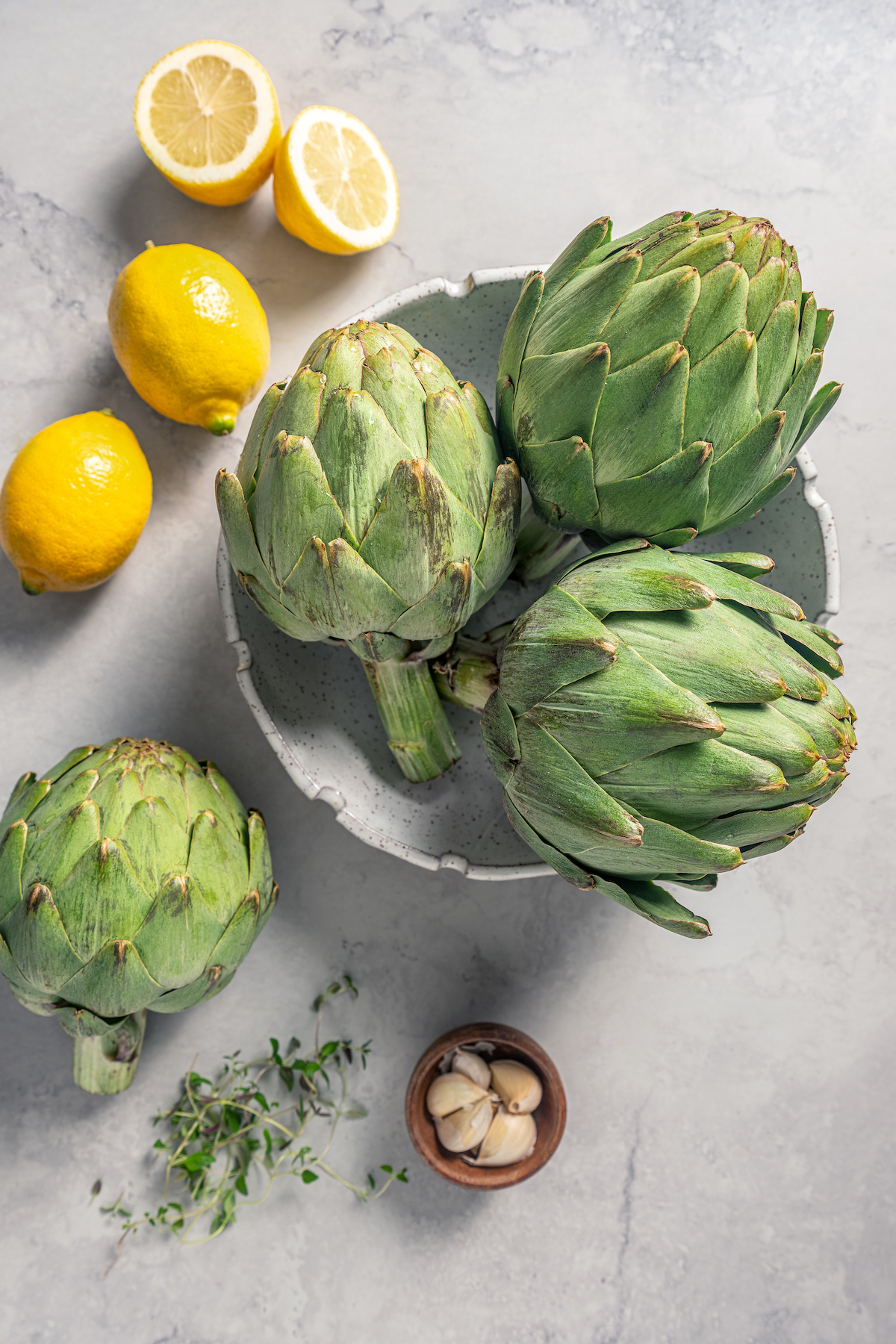 This tender Instant Pot artichokes recipe with hints of tangy lemon, garlic, and fresh herbs will be your go-to holiday side dish. Ingredients for Instant Pot artichokes.