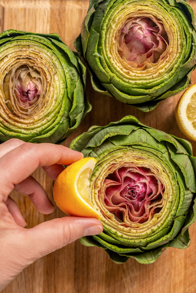 This tender Instant Pot artichokes recipe with hints of tangy lemon, garlic, and fresh herbs will be your go-to holiday side dish. Rubbing the artichokes with lemon.