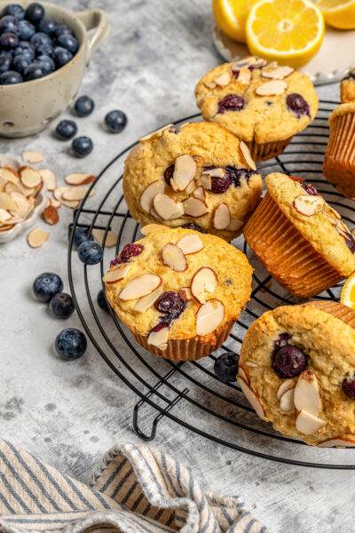 Lemon-blueberry ricotta muffins on a cooling rack.