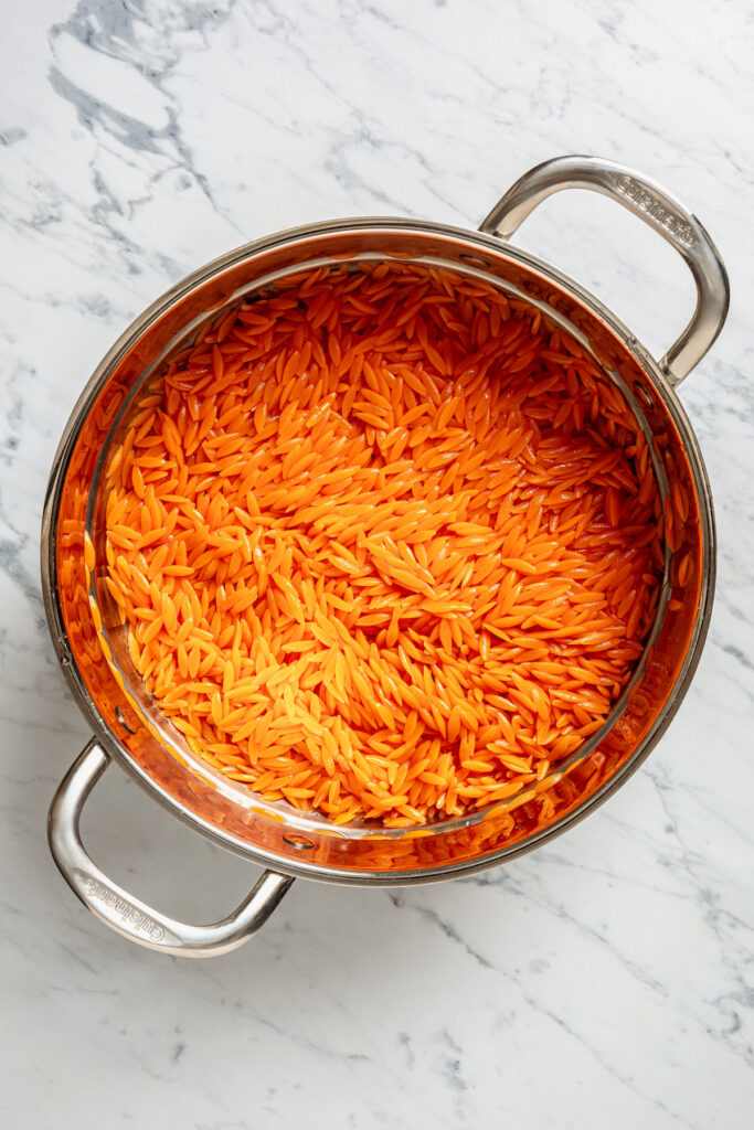 This vibrant Orzo Salad is made with beets, pasta, toasted pine nuts, and blue cheese - a wholesome side dish that everyone will love. Orzo cooked in water from boiled beets.