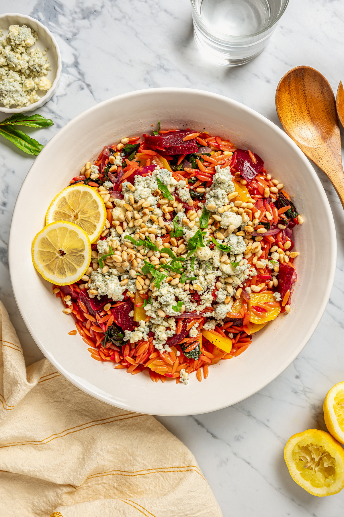 This vibrant Orzo Salad is made with beets, pasta, toasted pine nuts, and blue cheese - a wholesome side dish that everyone will love. Homemade beet salad with orzo.