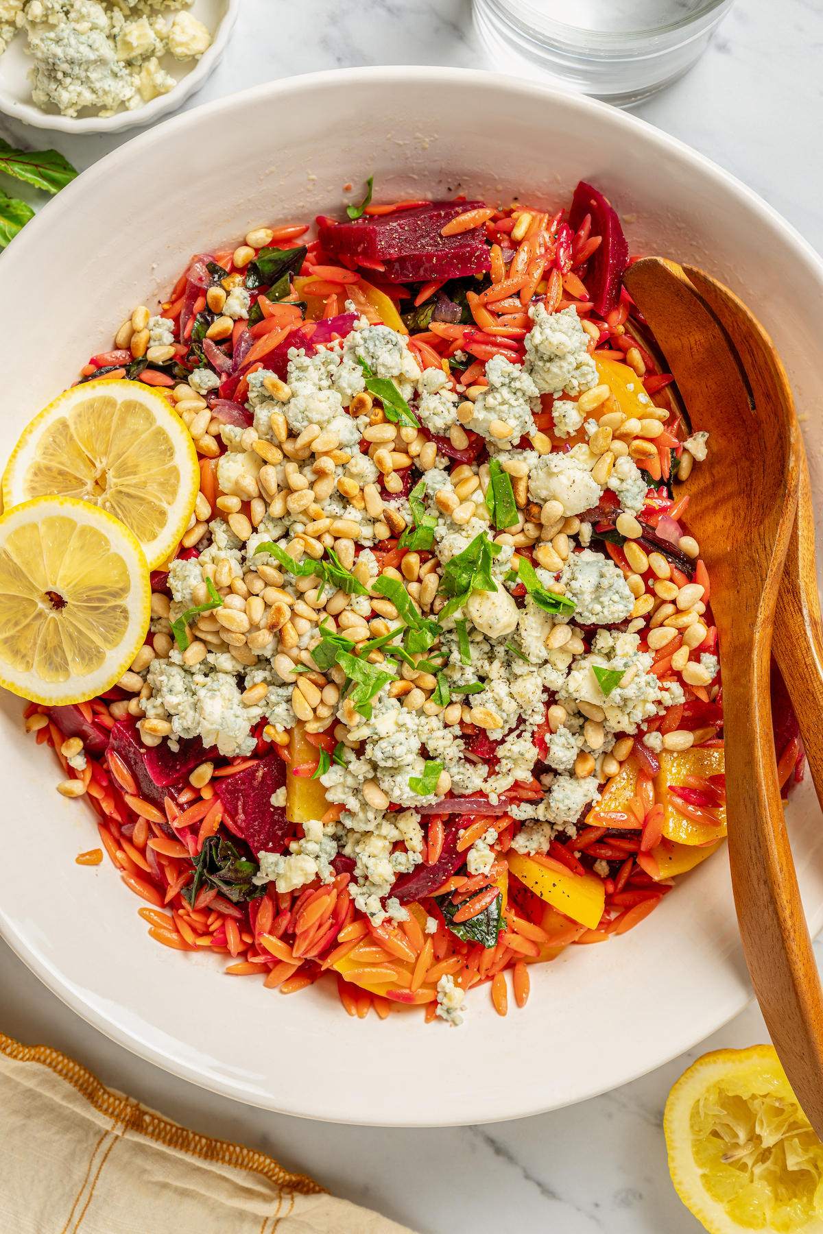 This vibrant Orzo Salad is made with beets, pasta, toasted pine nuts, and blue cheese - a wholesome side dish that everyone will love. Pasta salad with beets and blue cheese.