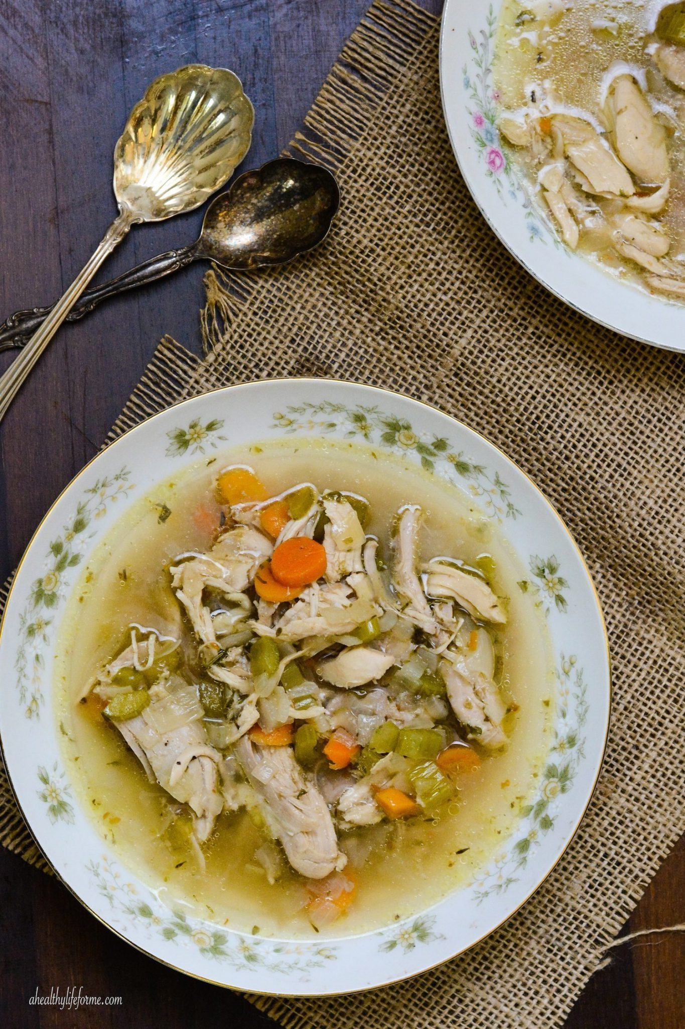 This easy paleo chicken soup recipe with fresh veggies and herbs is a comforting weeknight dinner you'll love. Paleo chicken soup in a bowl.