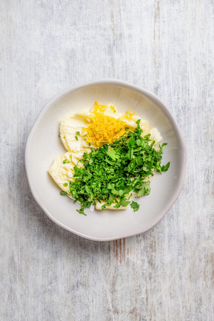 Sweet, fresh corn is a must-have in the summer, and this easy Grilled Corn is loaded with a unique nutty taste that you're sure to love! Making compound butter with cilantro and lemon.