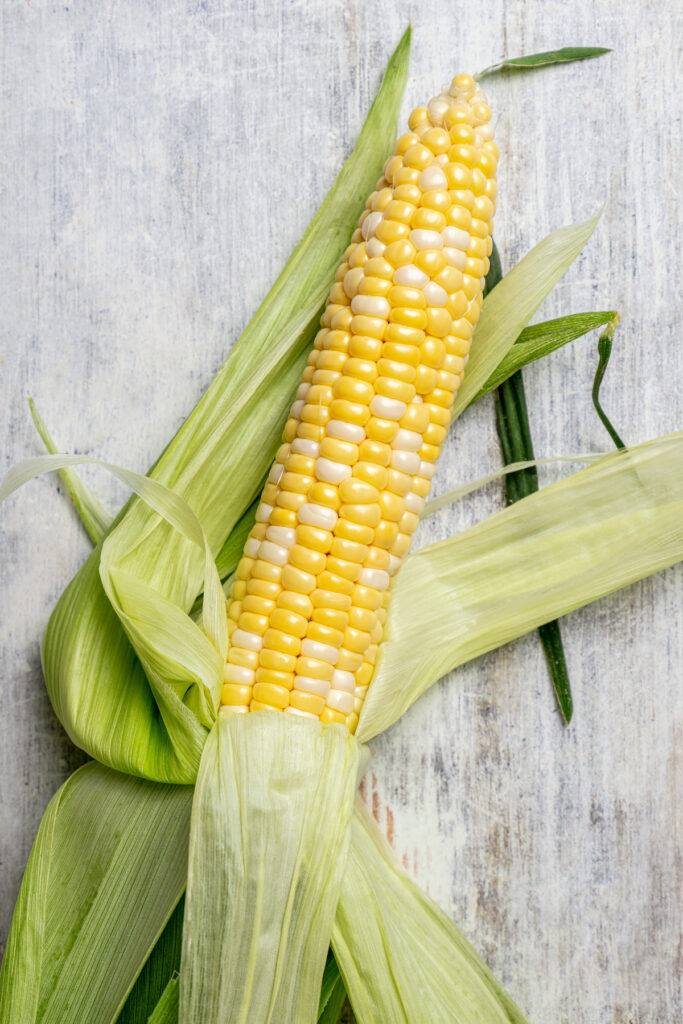 Sweet, fresh corn is a must-have in the summer, and this easy Grilled Corn is loaded with a unique nutty taste that you're sure to love! An ear of corn with the husk pulled back and silks removed.