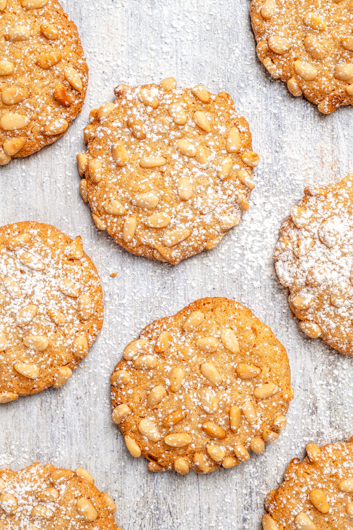 Italian Pignoli Cookies are crispy, chewy and almond-y, topped with rich, creamy pine nuts. They're sure to become a family favorite! Pignoli cookies dusted with powdered sugar.
