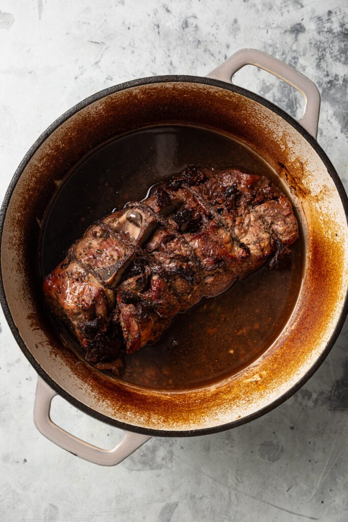 This sweet-and-savory pork shoulder recipe with honey, red wine-fig sauce, and lots of fruity figs is perfect for Thanksgiving dinners. Roasted pork in the Dutch oven with its cooking juices.