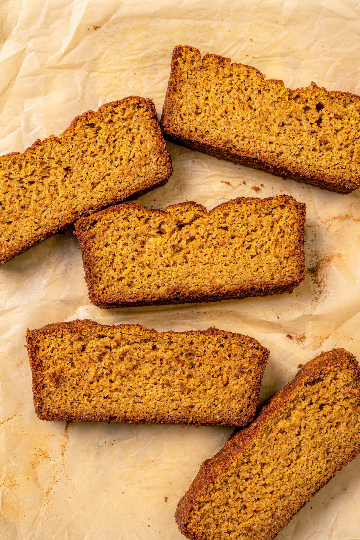 This tender paleo pumpkin bread recipe with vegan flours, coconut cream, and maple syrup is an easy fall-flavored dessert. Slices of fluffy paleo pumpkin bread.