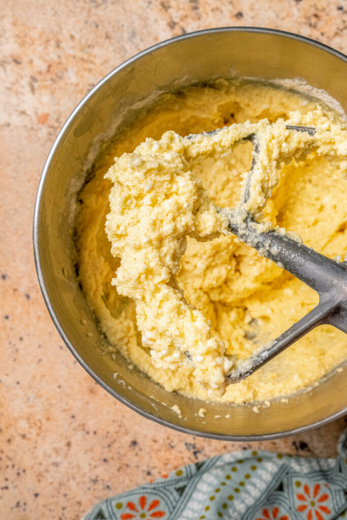 This buttery breakfast muffins recipe is packed with creamy cottage cheese and parmesan for a tender bite. Close-up of the batter's texture.